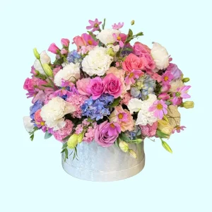 Felicidad arreglo de rosas hortensias y lisianthus en tonos rosas y lilas
